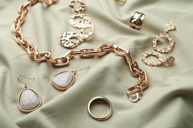 Hafif zeytin kumaşında şık altın bijouterie