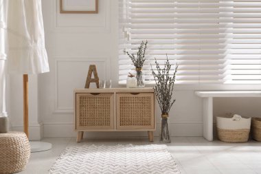 Light room interior with pussy willow tree branches