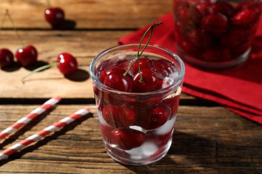 Ahşap masada buzlu kırmızı kirazlar.