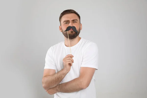 Young Man Fake Mustache Light Grey Background — Stock Photo, Image