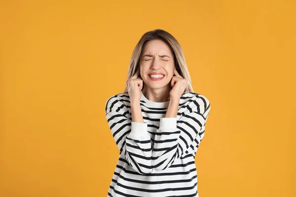 Emotional Young Woman Covering Her Ears Fingers Yellow Background — Stock Photo, Image