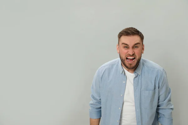 Angry Young Man Grey Background Space Text Hate Concept — Stock Photo, Image