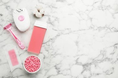 Beyaz mermer sehpada düz bir sette epilasyon ürünleri var. Metin için boşluk