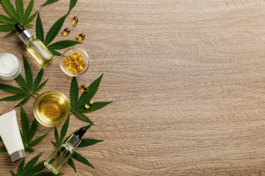 Kenevir yapraklı düz bileşim, CBD yağı ve ahşap masada THC tentürü, metin için boşluk