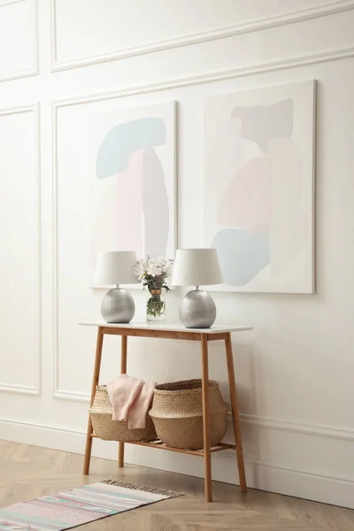 Elegant room interior with console table and beautiful flowers bouquet