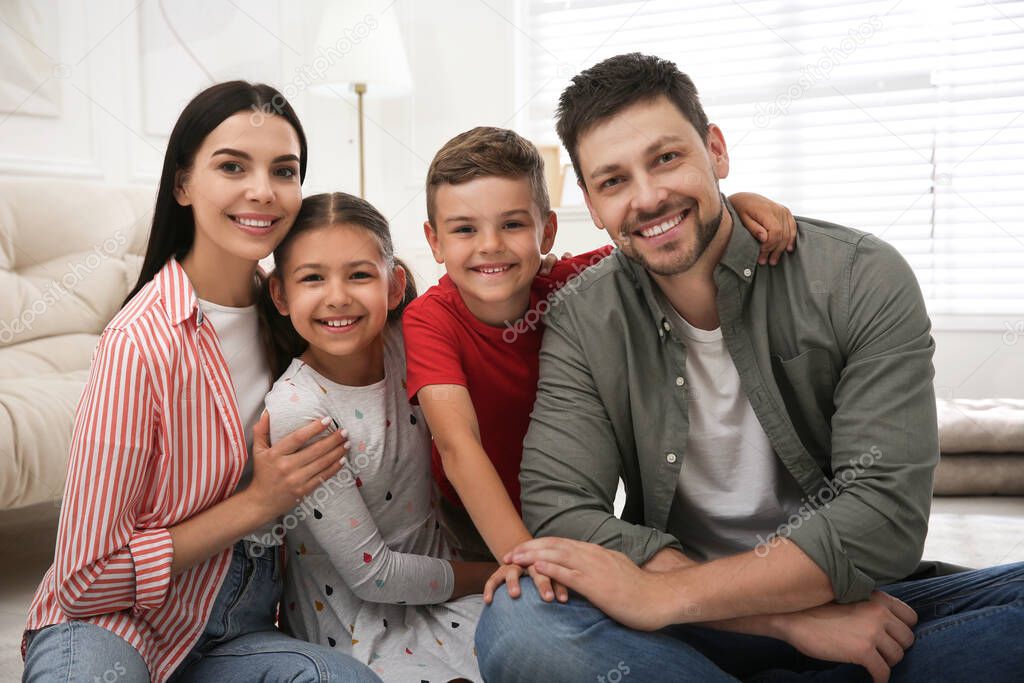 Portrait of happy family in living room. Adoption concept