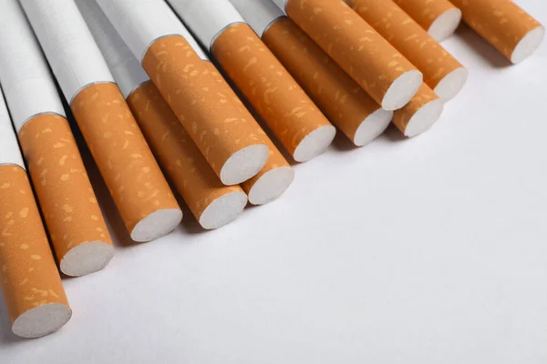 Pile Cigarettes Orange Filters White Background Closeup Space Text — Stock Photo, Image