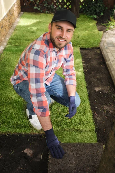 Ung Man Lägger Gräs Sod Marken Bakgården — Stockfoto