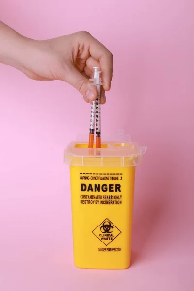 Woman Throwing Used Syringes Sharps Container Pink Background Closeup — Stock Photo, Image