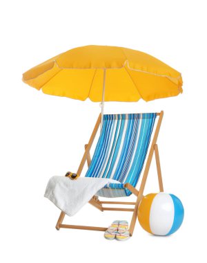 Open yellow beach umbrella, deck chair, inflatable ball and accessories on white background clipart