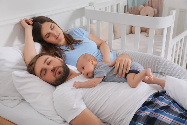 Tired Young Parents Baby Sleeping Bed Home — Stock Photo, Image