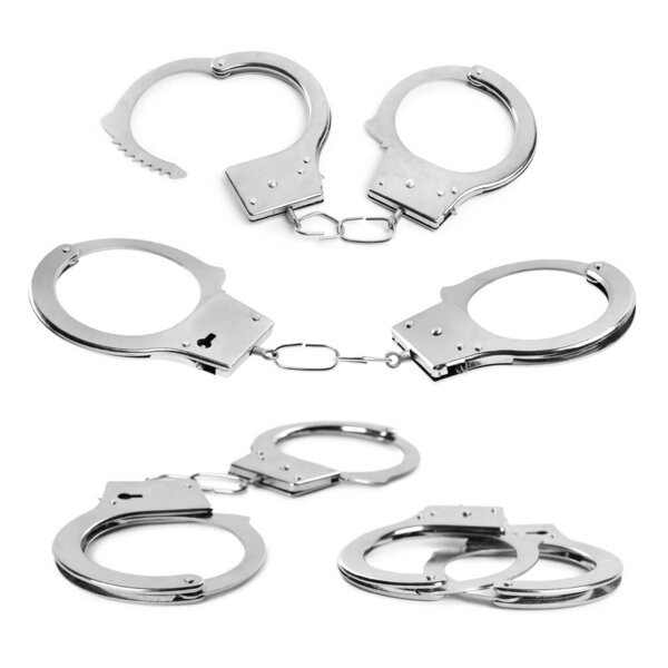 Set with classic chain handcuffs on white background