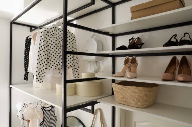 Giysiler ve aksesuarlar için depolama rafı olan dolap.