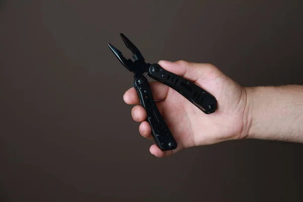 Man Holding Multitool Brown Background Closeup — Stock Photo, Image