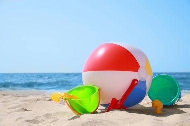 Farklı kum oyuncakları ve deniz kenarında plaj topu.