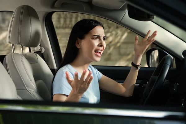 Stressed young woman driver\'s seat of modern car