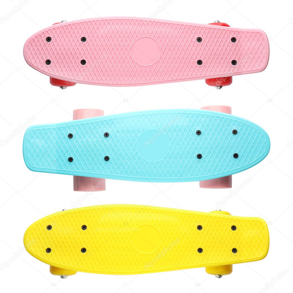 Set with different colorful skateboards on white background, top view. Sport equipment