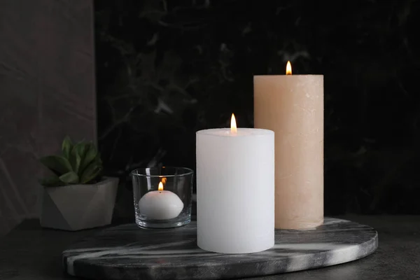 Marmorplatte Mit Brennenden Kerzen Auf Dunklem Tisch — Stockfoto