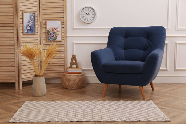 Modern room interior with light rug and stylish furniture