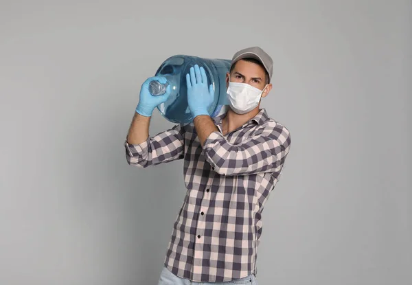 Courier Medical Mask Holding Bottle Water Cooler Light Grey Background — Stock Photo, Image