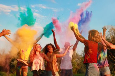 Mutlu arkadaşlar açık havada renkli pudra boyalarıyla eğleniyorlar. Holi festivali kutlaması