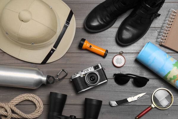 Flat lay composition with safari accessories on wooden background