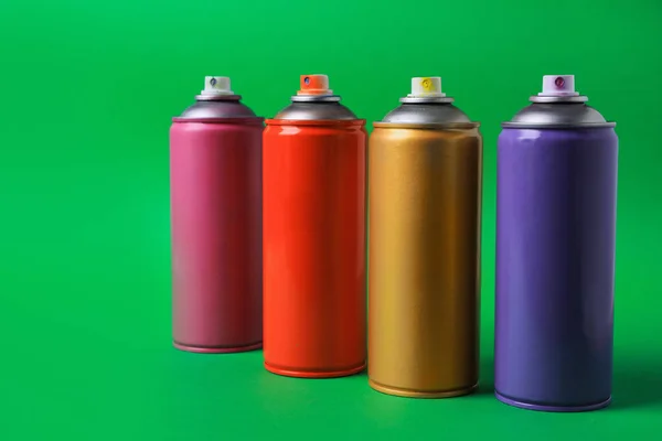 Cans Different Graffiti Spray Paints Green Background — Stock Photo, Image