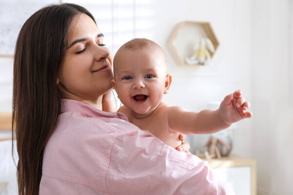 Mother with her cute baby at home