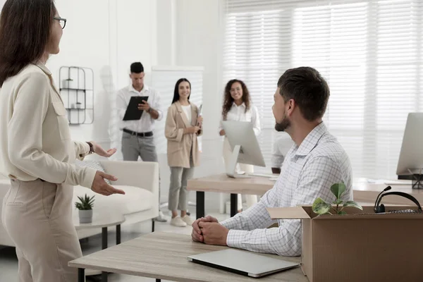 Boss introducing new employee to coworkers in office