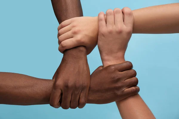 Men Joining Hands Together Light Blue Background Closeup — Stock Photo, Image