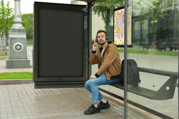 Young Man Listening Music While Waiting Public Transport Bus Stop — Stock Photo, Image