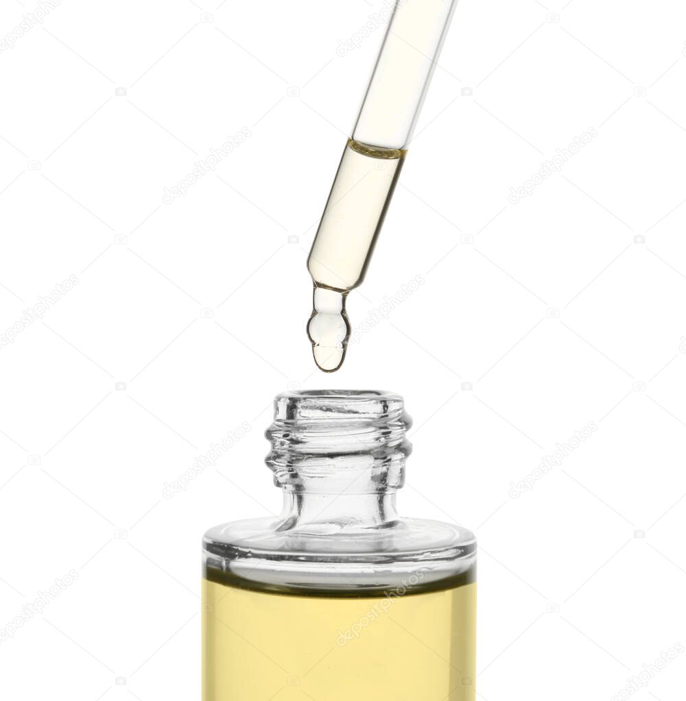 Dripping oil from pipette into glass bottle isolated on white, closeup