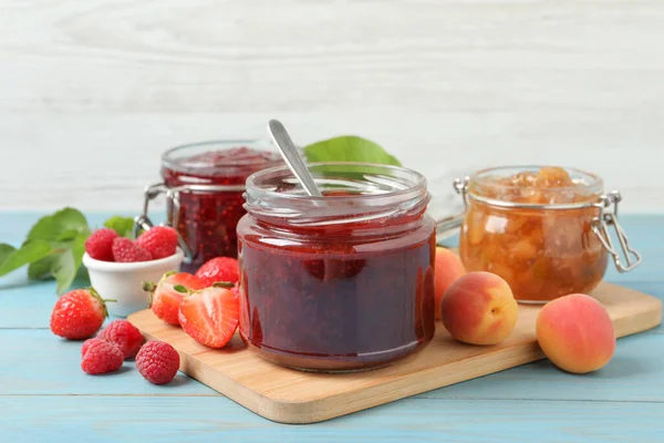 Jars Different Jams Fresh Fruits Light Blue Wooden Table — Stock Photo, Image