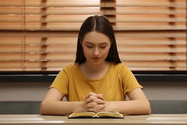 Religious Young Woman Praying Bible Wooden Table Indoors — Stock Photo, Image