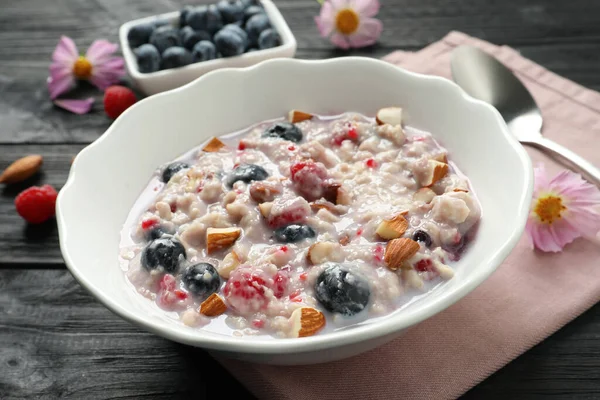 Tasty Oatmeal Porridge Toppings Black Wooden Table Closeup — Stock Photo, Image