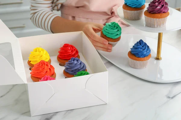 Woman Putting Delicious Colorful Cupcakes Dessert Stand White Marble Table — Stock Photo, Image