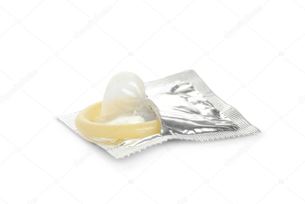 Unpacked beige condom isolated on white. Safe sex