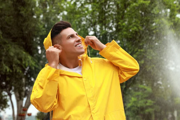 公园里穿着雨衣的人在雨中行走 — 图库照片