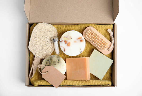 Cardboard box with eco friendly personal care products on white background, top view