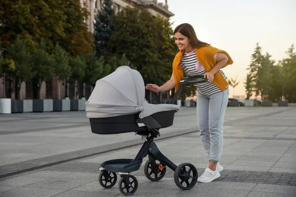 Young Mother Walking Her Baby Stroller Outdoors — Stock Photo, Image