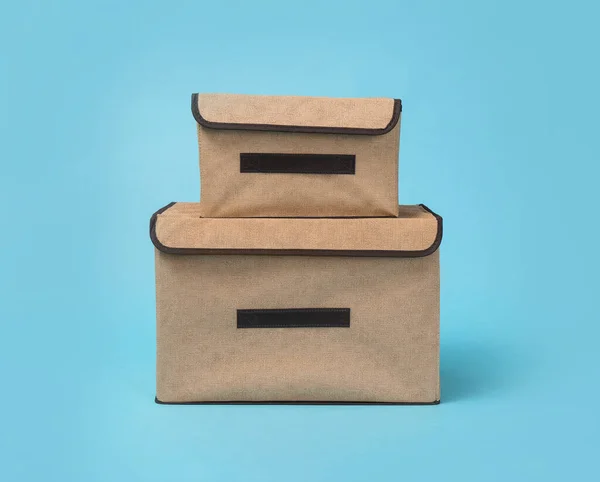 Two textile storage cases on light blue background