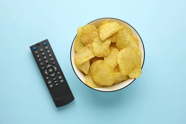 Remote Control Bowl Potato Chips Light Blue Background Flat Lay — Stock Photo, Image