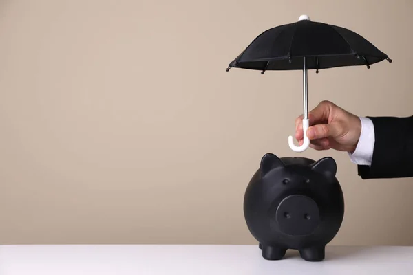 Woman Holding Small Umbrella Piggy Bank Beige Background Closeup Space — Stock Photo, Image