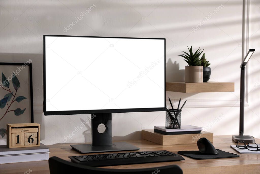 Stylish workplace with modern computer near white wall indoors. Space for text