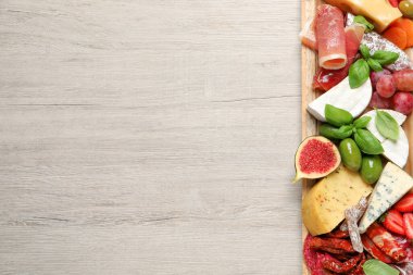 Beyaz ahşap masada servis edilen farklı lezzetli aperatifler, üst manzara. Metin için boşluk