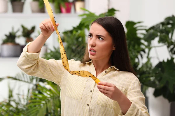 Emotionele Vrouw Met Plakkerige Insectentape Met Dode Vliegen Binnen — Stockfoto