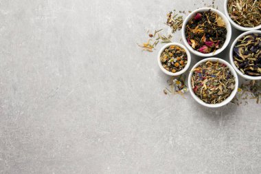 Açık gri tablo üzerinde farklı kuru çaylarla düz konum, metin için boşluk