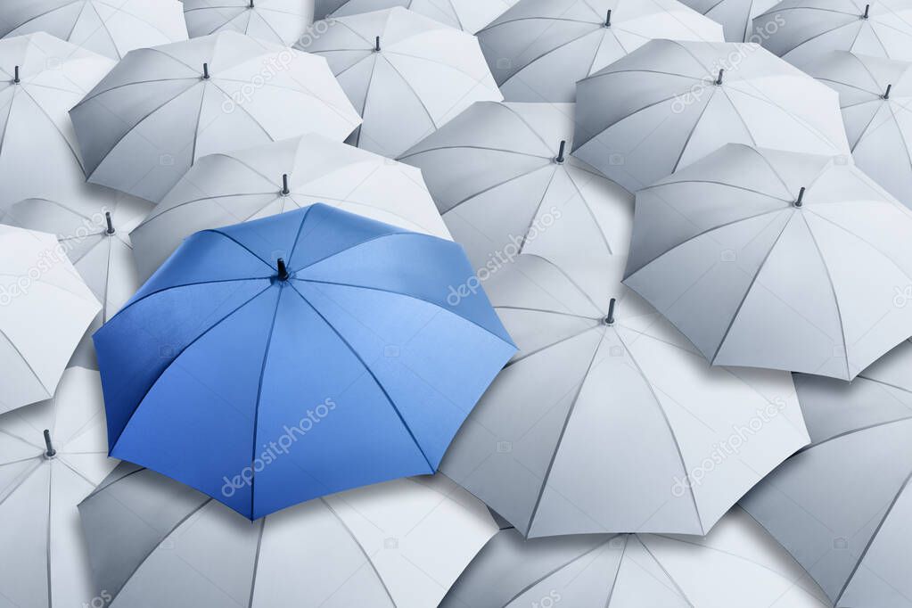 Blue umbrella standing out of other ones, above view