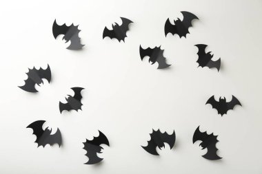 Cadılar Bayramı dekoru. Beyaz zemin üzerinde siyah kağıt yarasalardan yapılmış çerçeve düz. Metin için boşluk