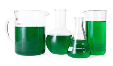 Beyaz üzerine yeşil sıvı izole edilmiş farklı laboratuvar camları.